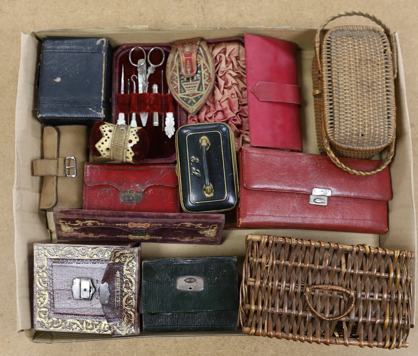 A large collection of mostly late 19th, early 20th century Morocco leather Etui a carved bone pin cushion and two miniature baskets. Largest basket 18cms wide